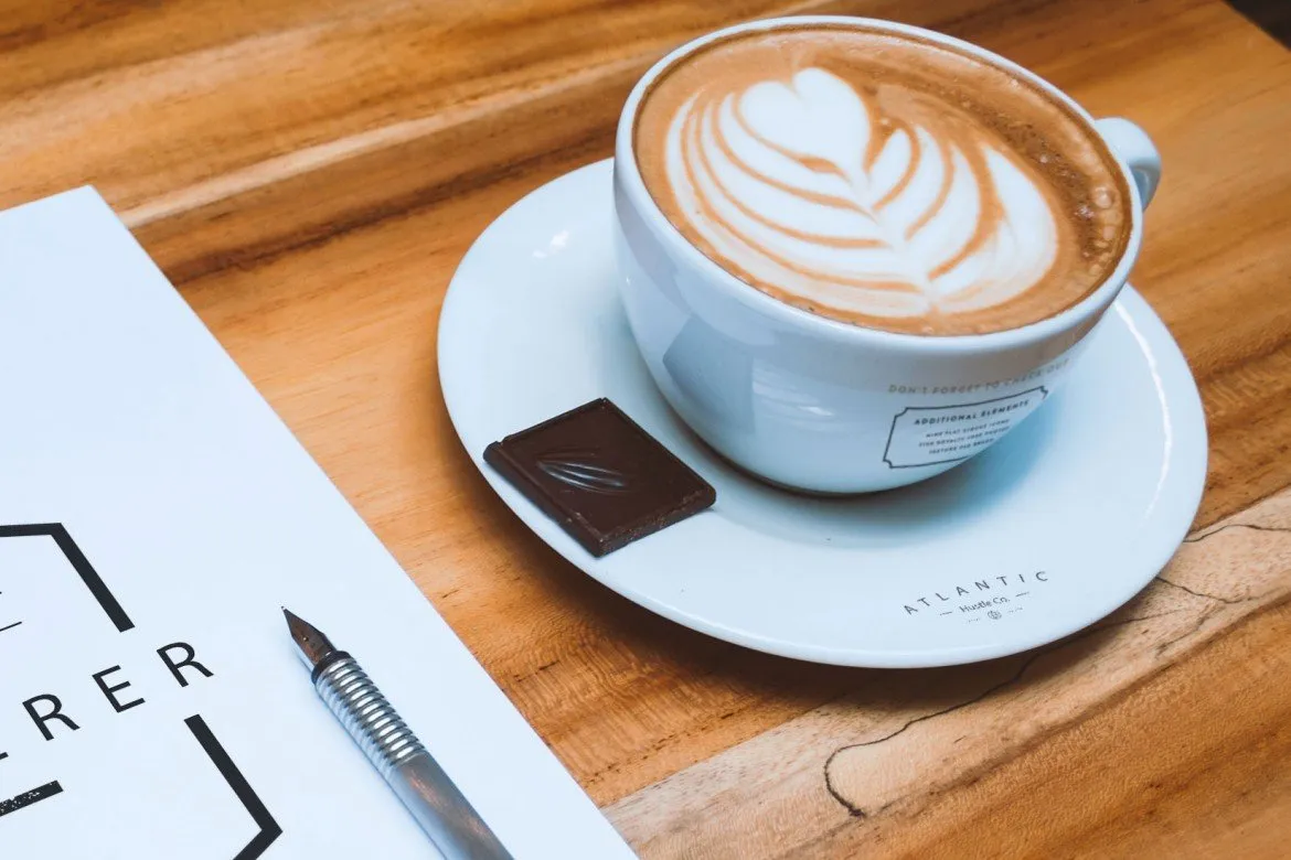 Free A4 Letterhead and Coffee Cup on Table (Mockup)